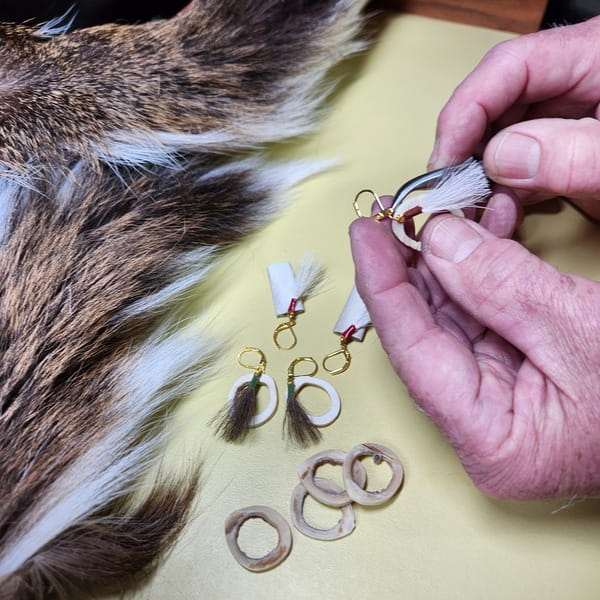 Close up of artisan's hands making the jewelry